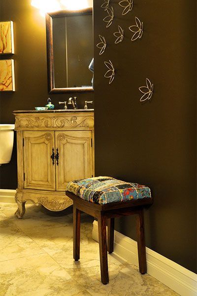 A bathroom with a sink , mirror and a stool