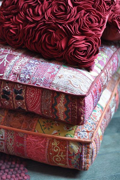 A stack of colorful pillows sitting on top of each other.