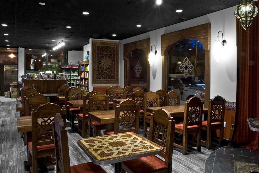 A dining room with tables and chairs in a restaurant.