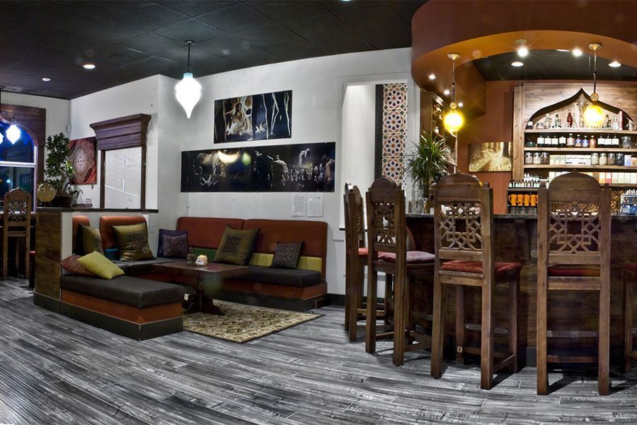 A living room with a couch and chairs and a bar