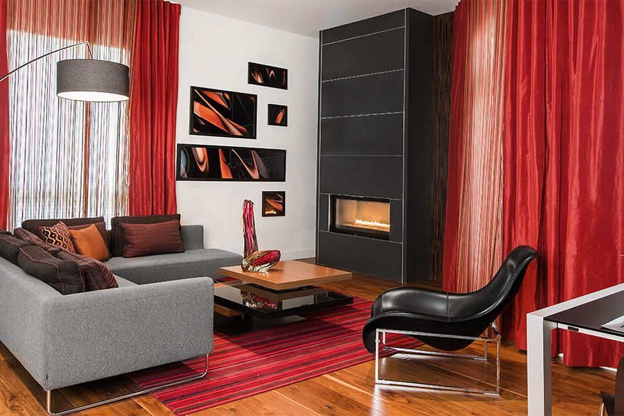 A living room with a couch , chair , coffee table and fireplace.