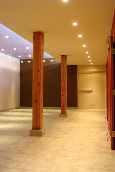 A hallway with wooden pillars in the middle of it