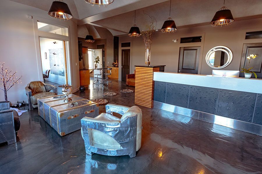 A living room with a couch , chairs , and a counter.