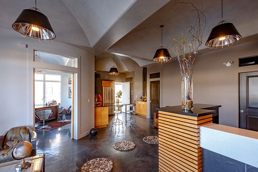 A living room with a wooden counter and a vase of flowers on it.