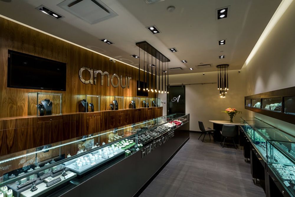 A jewelry store with lots of display cases and a wooden wall.