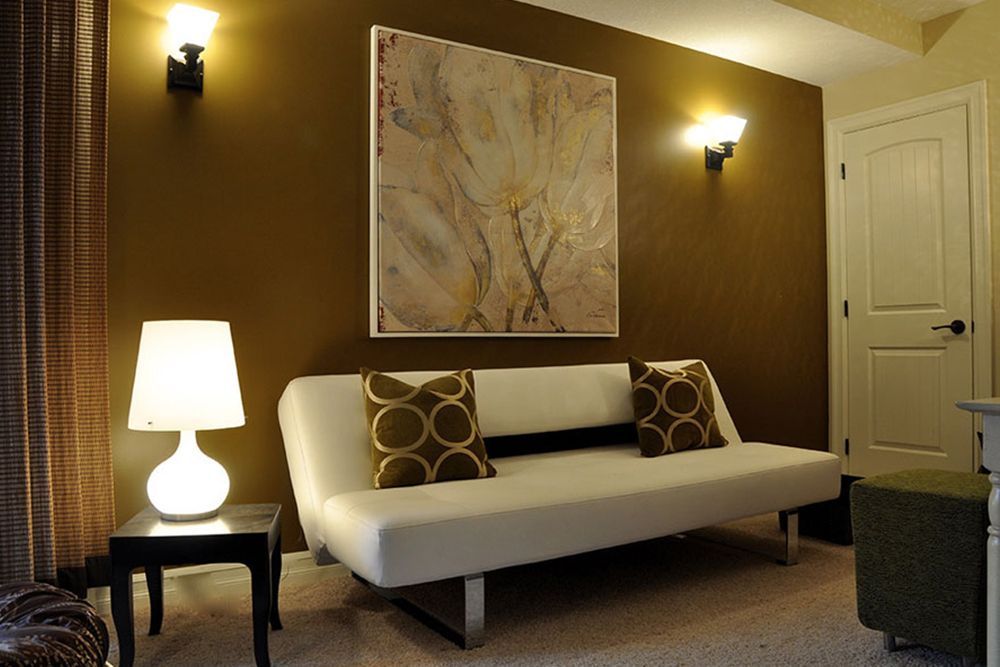 A living room with brown walls and a white couch