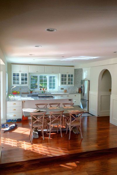 A kitchen with a table and chairs in it