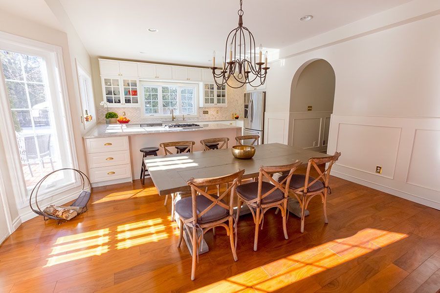 A dining room with a table and chairs and a chandelier.