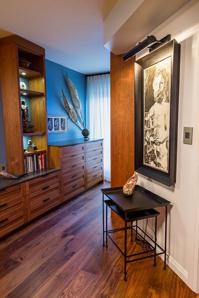 A hallway with wooden floors and a picture on the wall