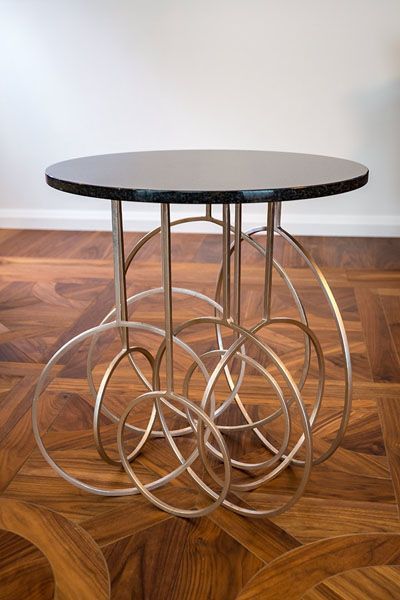 A round table with circles around it on a wooden floor
