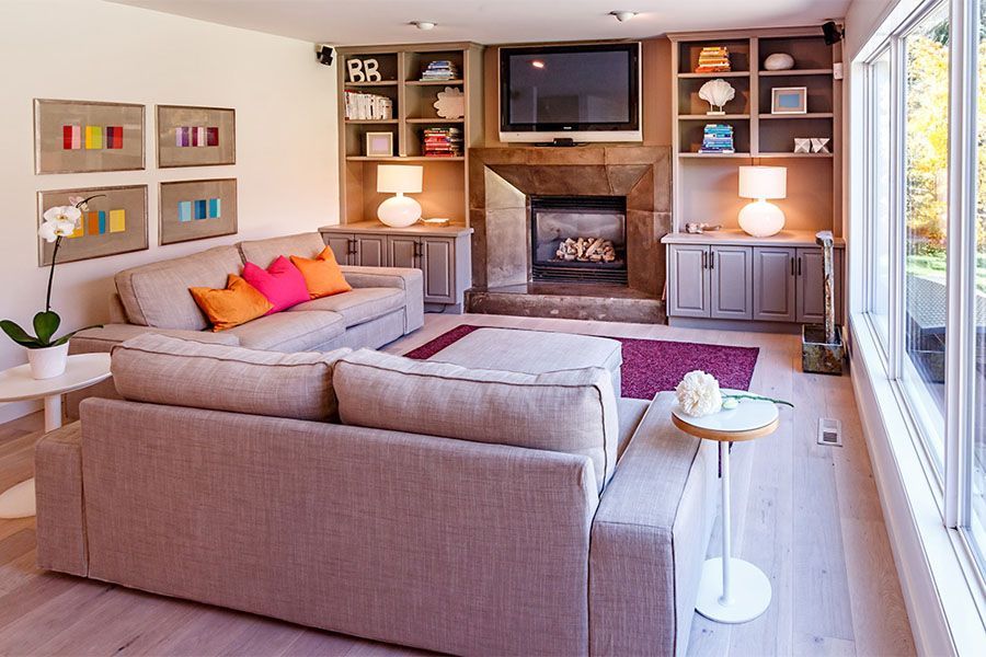 A living room with a couch a fireplace and a flat screen tv