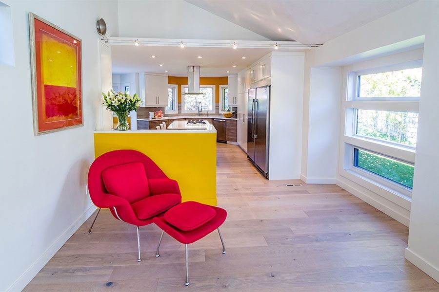 A living room with a red chair and ottoman