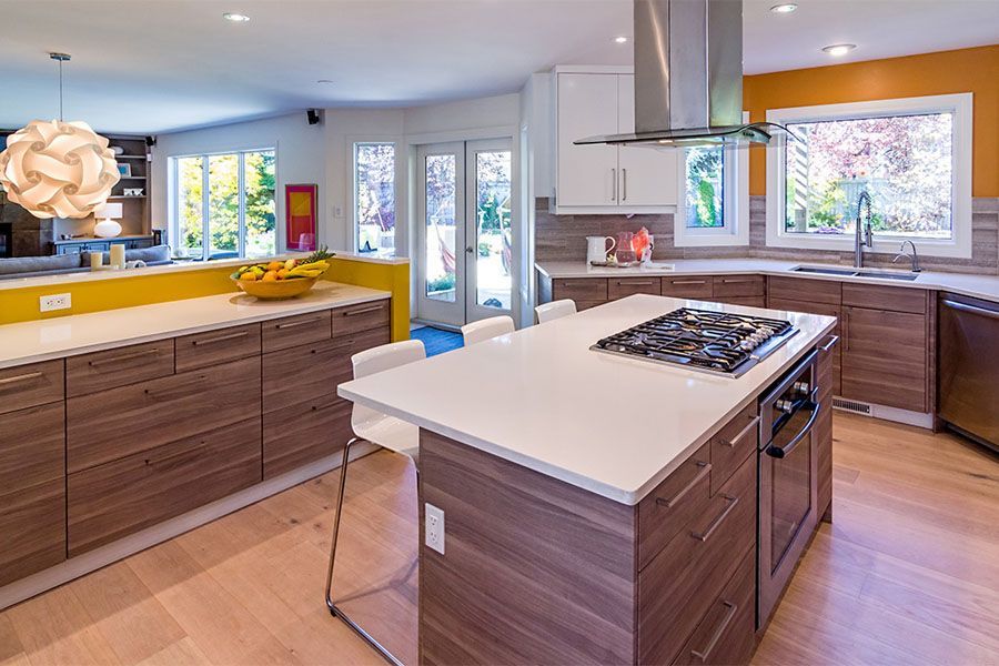 A kitchen with a large island and a stove top oven