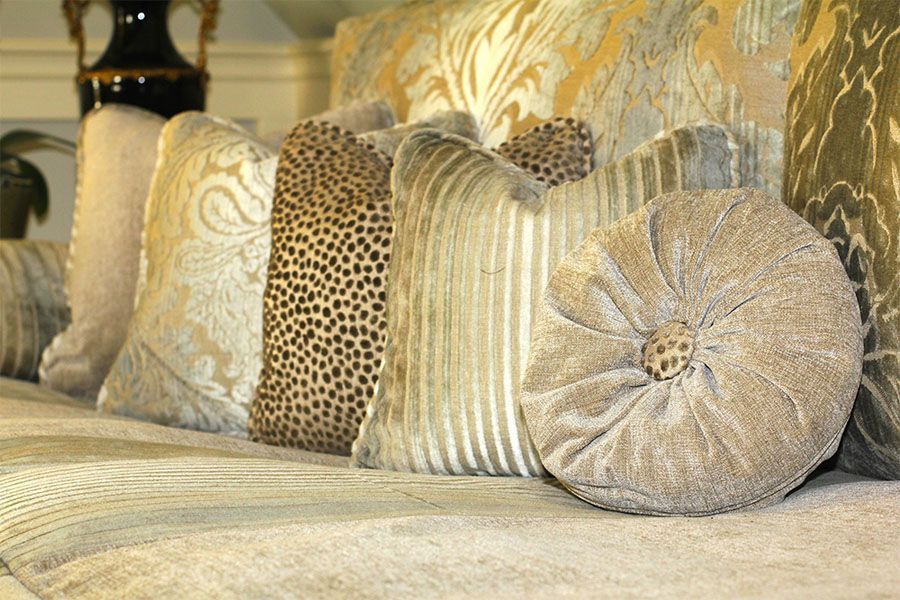 A couch with a lot of pillows on it