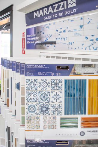 Tile display with various patterns and colors under a Marazzi sign.