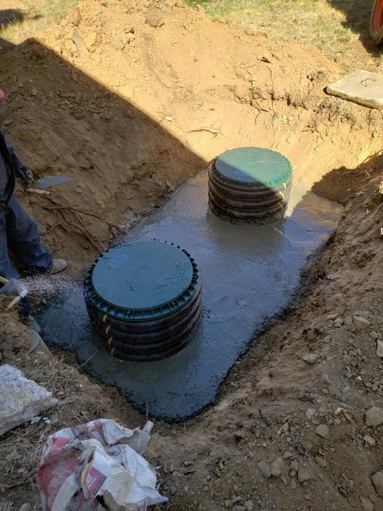 A septic tank is being built in a hole in the ground.
