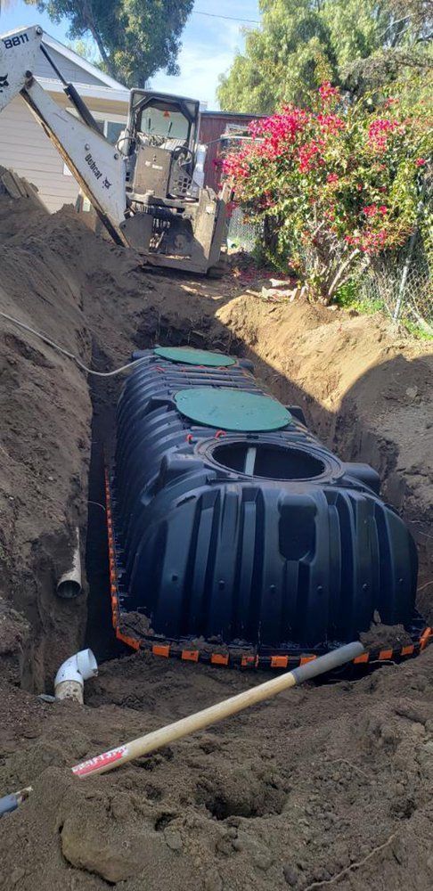 A septic tank is being installed in a hole in the ground.