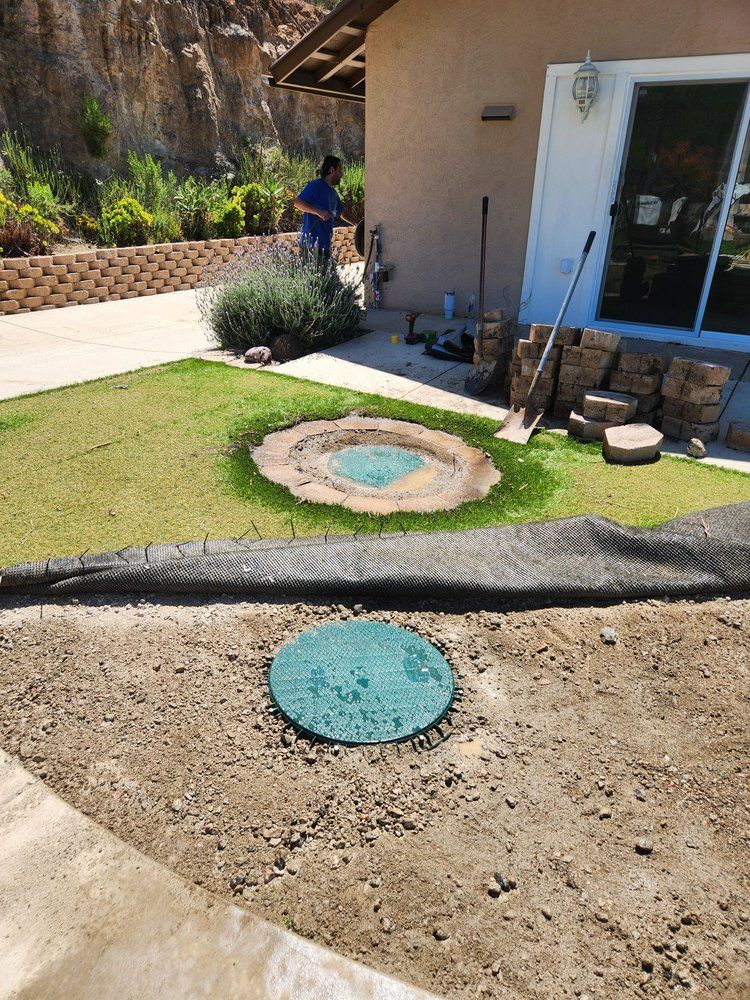 A man is working on a lawn in front of a house.