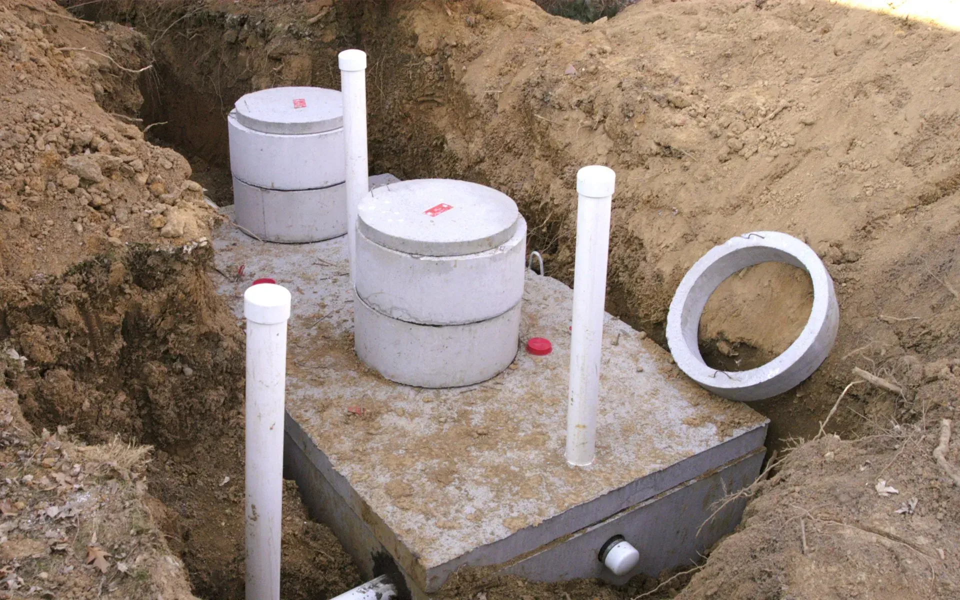 A septic tank is being installed in a hole in the ground.