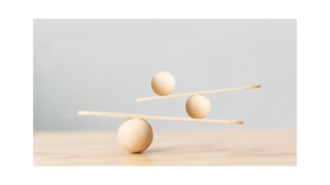 Three wooden eggs balanced on sticks.