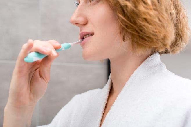 Woman Brushing Her Teeth — Naples, FL — Bradley Piotrowski, DDS, MSD, LLC