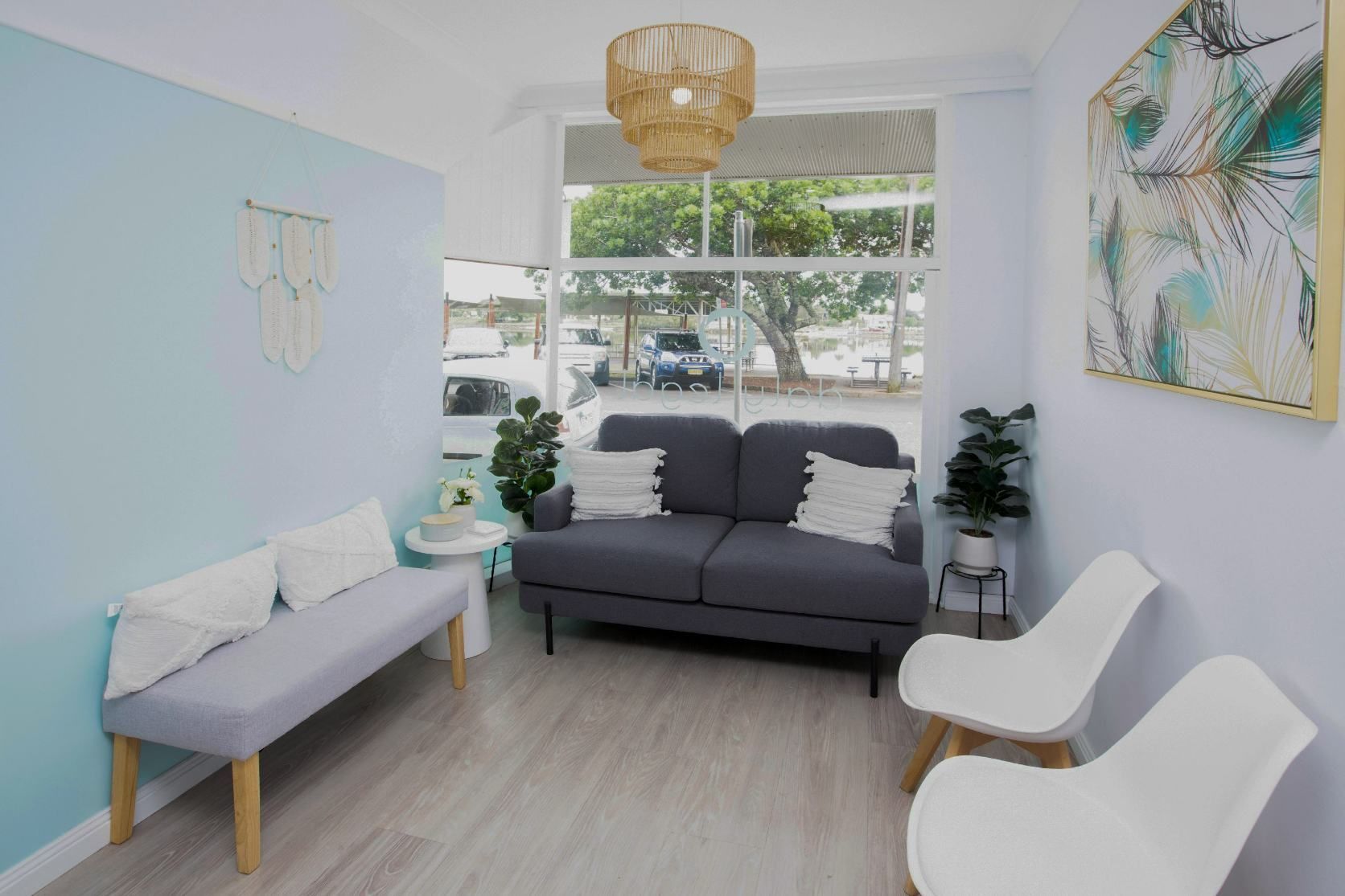 Waiting Room With Light Blue Walls, a Gray Sofa, and White Chairs — Daly Legal In Macksville, NSW