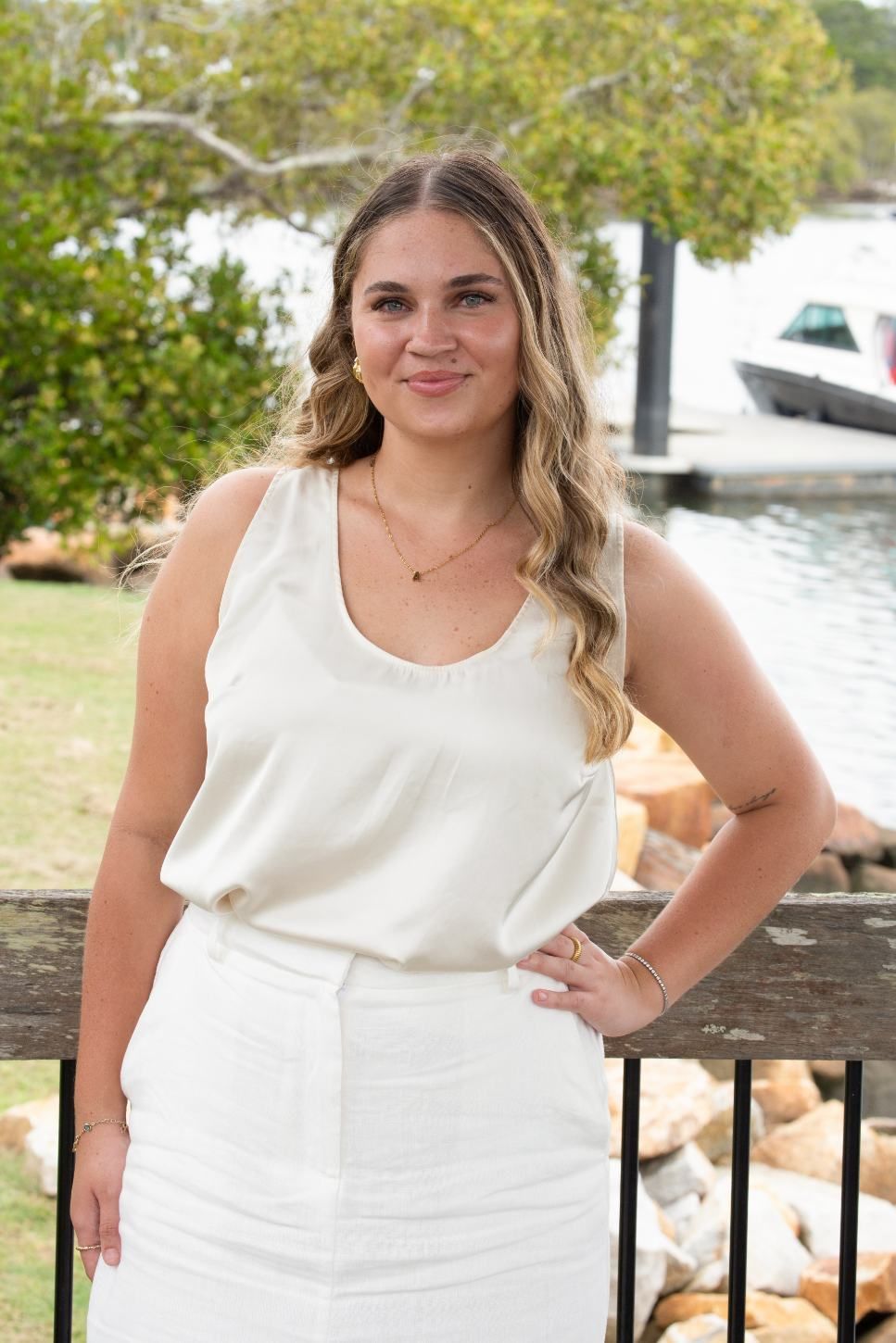 Woman With Long Blonde Hair and White Outfit, Smiles With Hand on Hip — Daly Legal In Macksville, NSW
