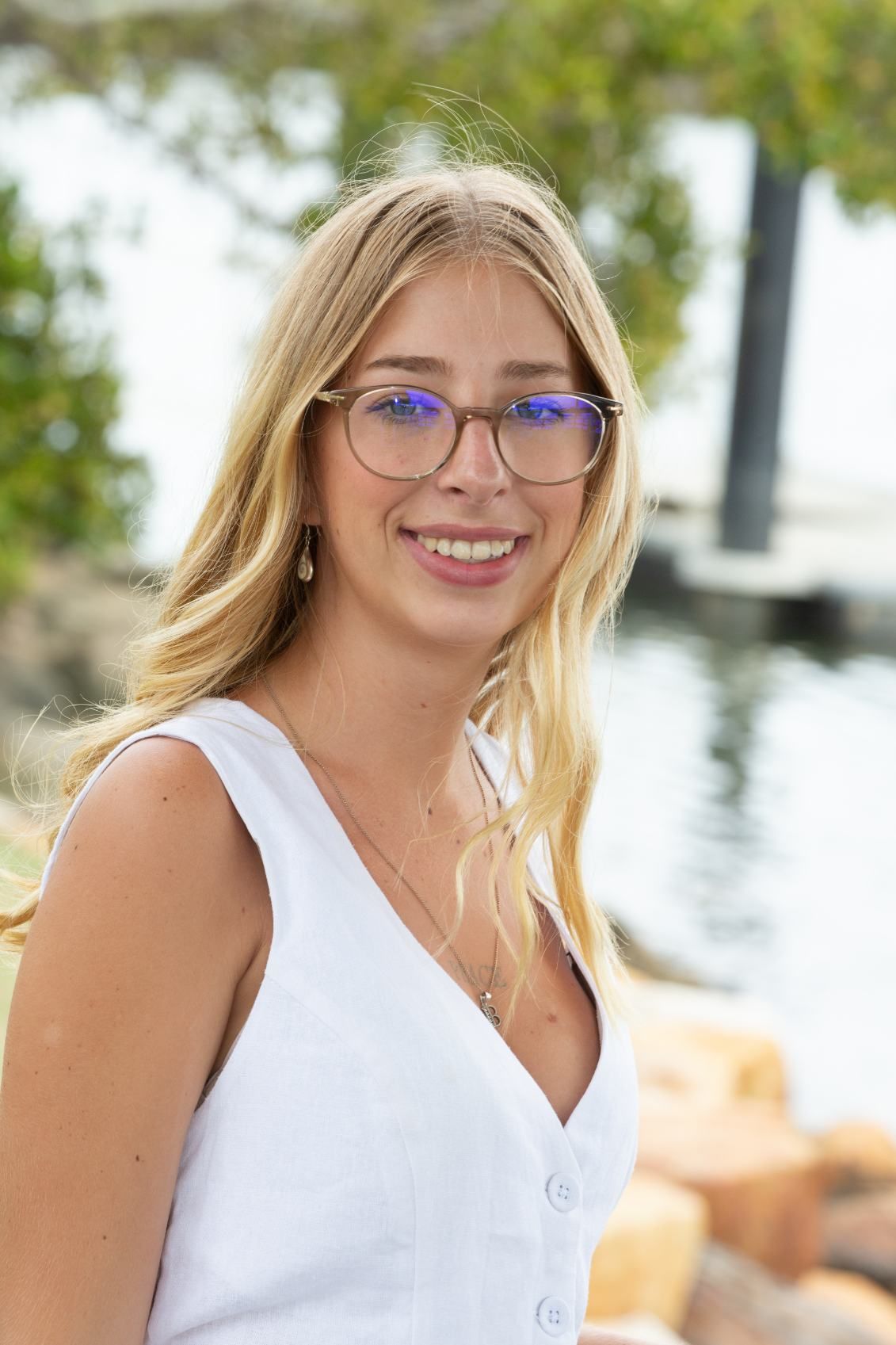 Young Blonde Woman Wearing Glasses and a White Top — Daly Legal In Macksville, NSW