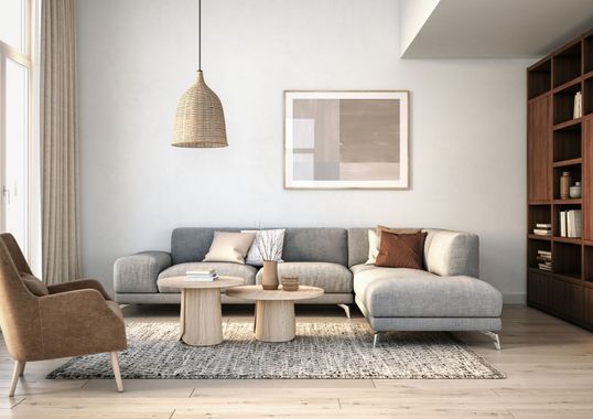 A living room with a couch , chairs , a coffee table and a picture on the wall.