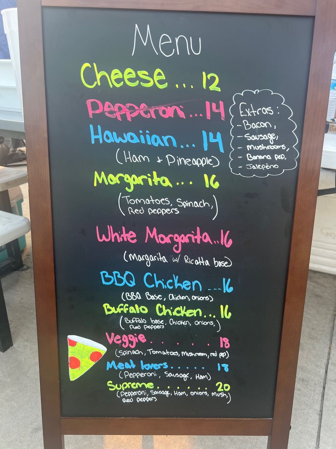A chalkboard displays a menu including cheese pepperoni and margarita