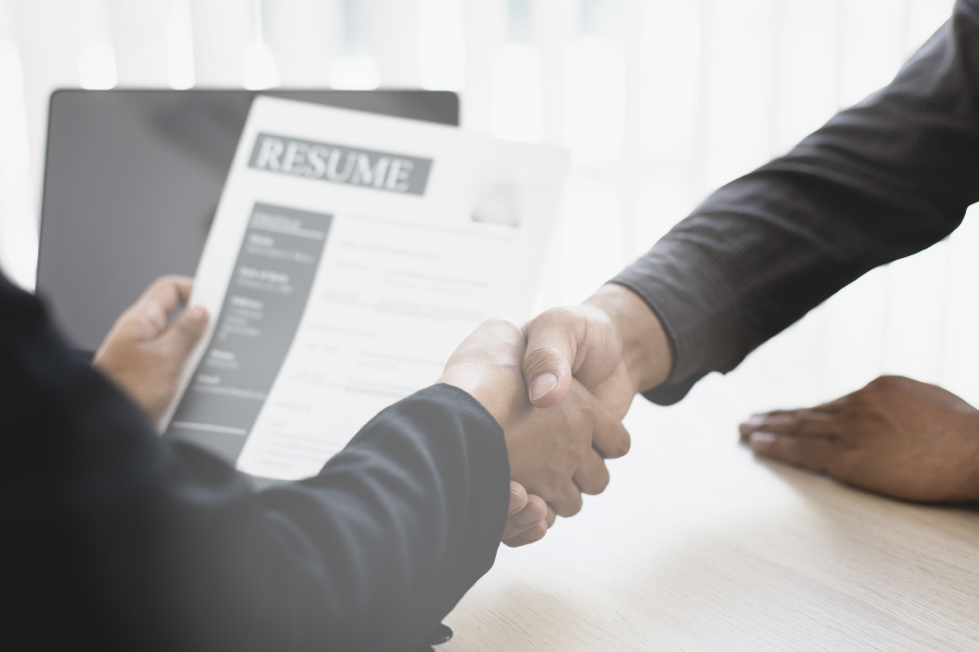two women are sitting next to each other and talking in front of a clock .