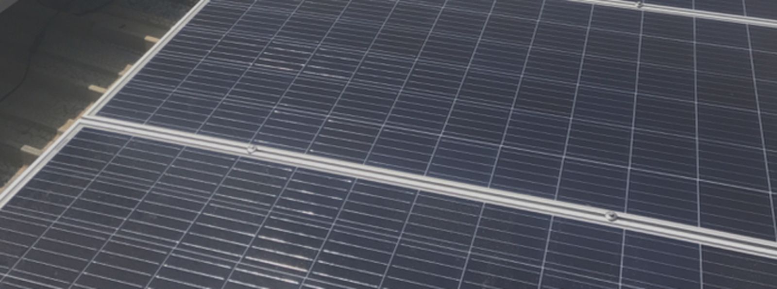 A close up of a solar panel on a roof.