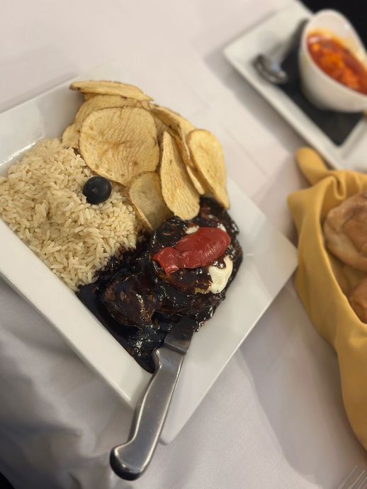 A plate of food with rice and chips on a table