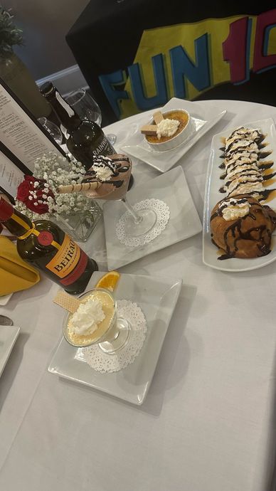 A table topped with plates of food and a bottle of wine.