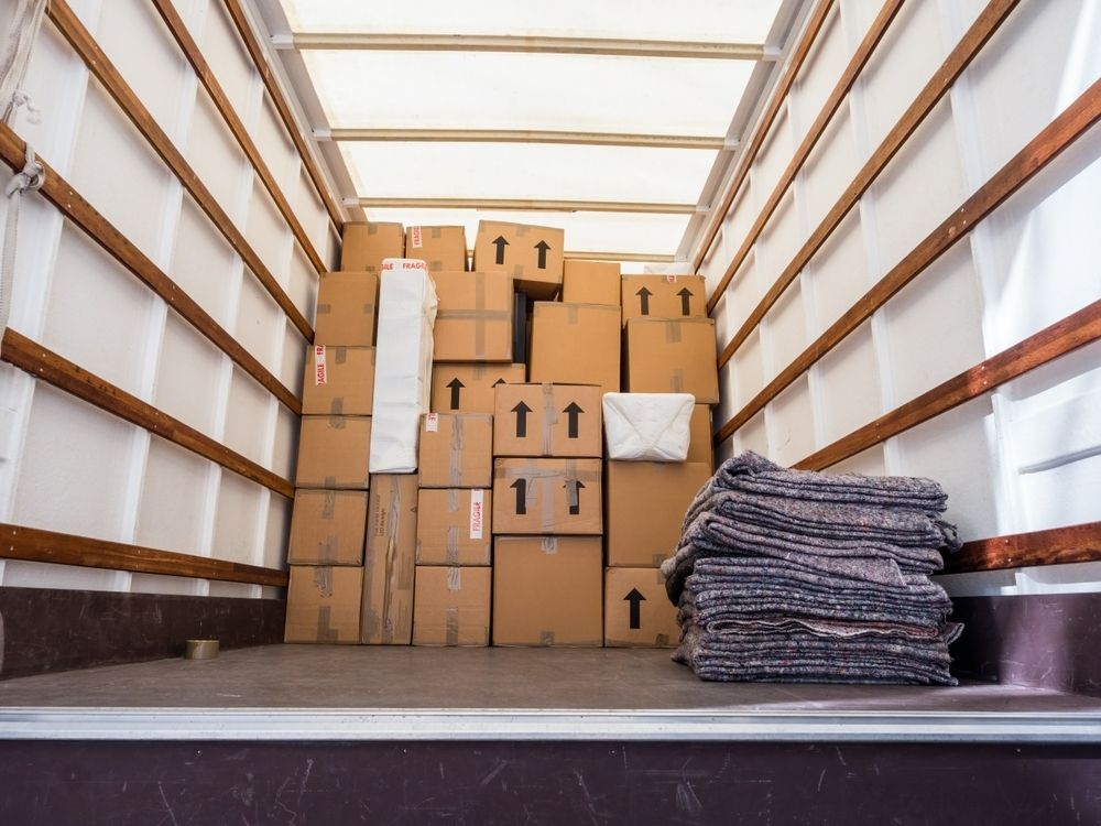 Boxes and Blankets Packed Inside a Cargo Truck, Ready for Transport — Premier Removals & Storage In Boambee, NSW