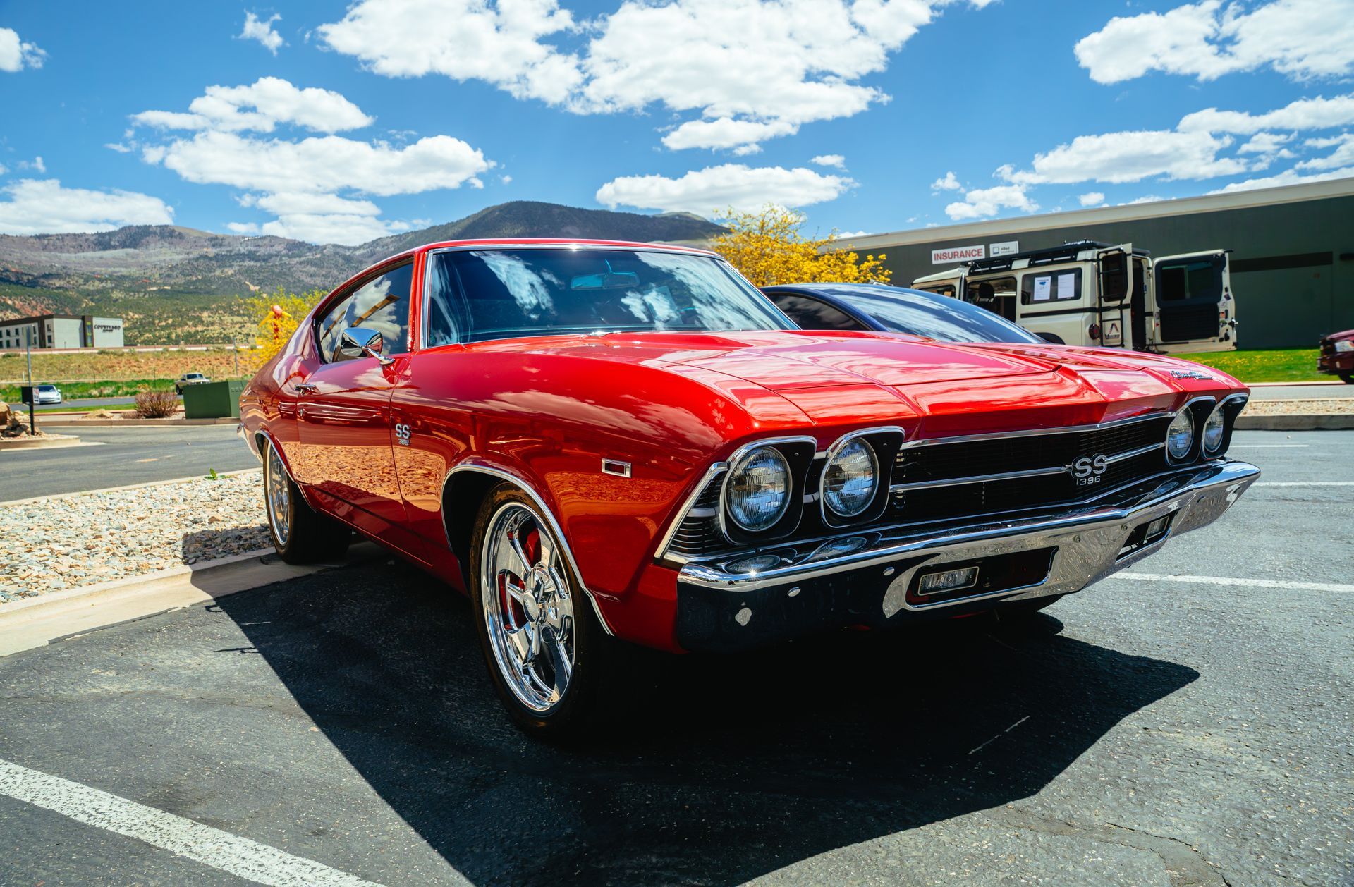 A white jeep rubicon is parked in a garage.