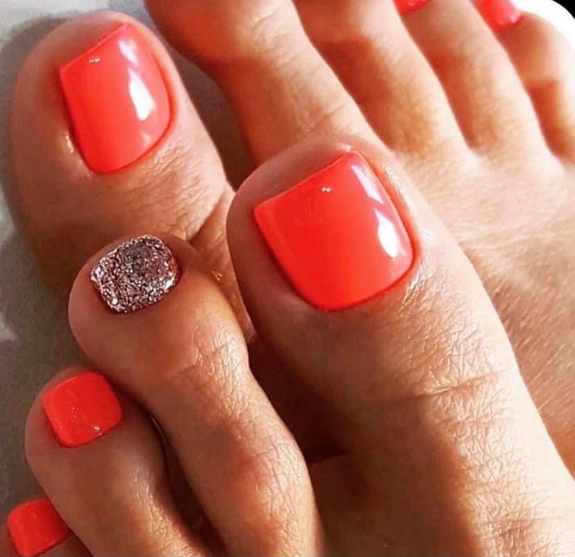 A Close Up Of A Woman's Feet With Bright Orange Nails — Beauty Abode in Buderim, QLD