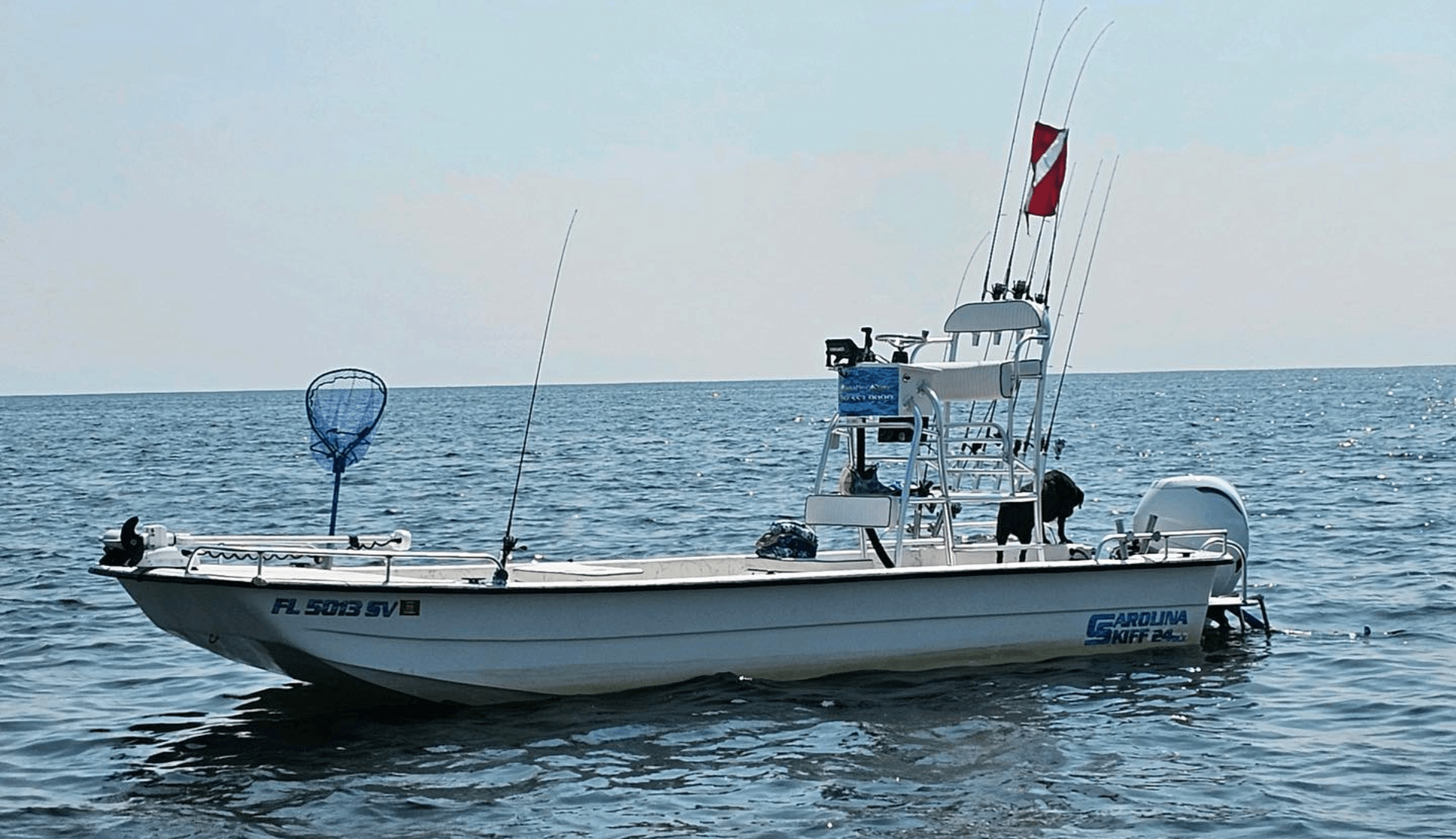 A white boat with a license plate that says florida on it