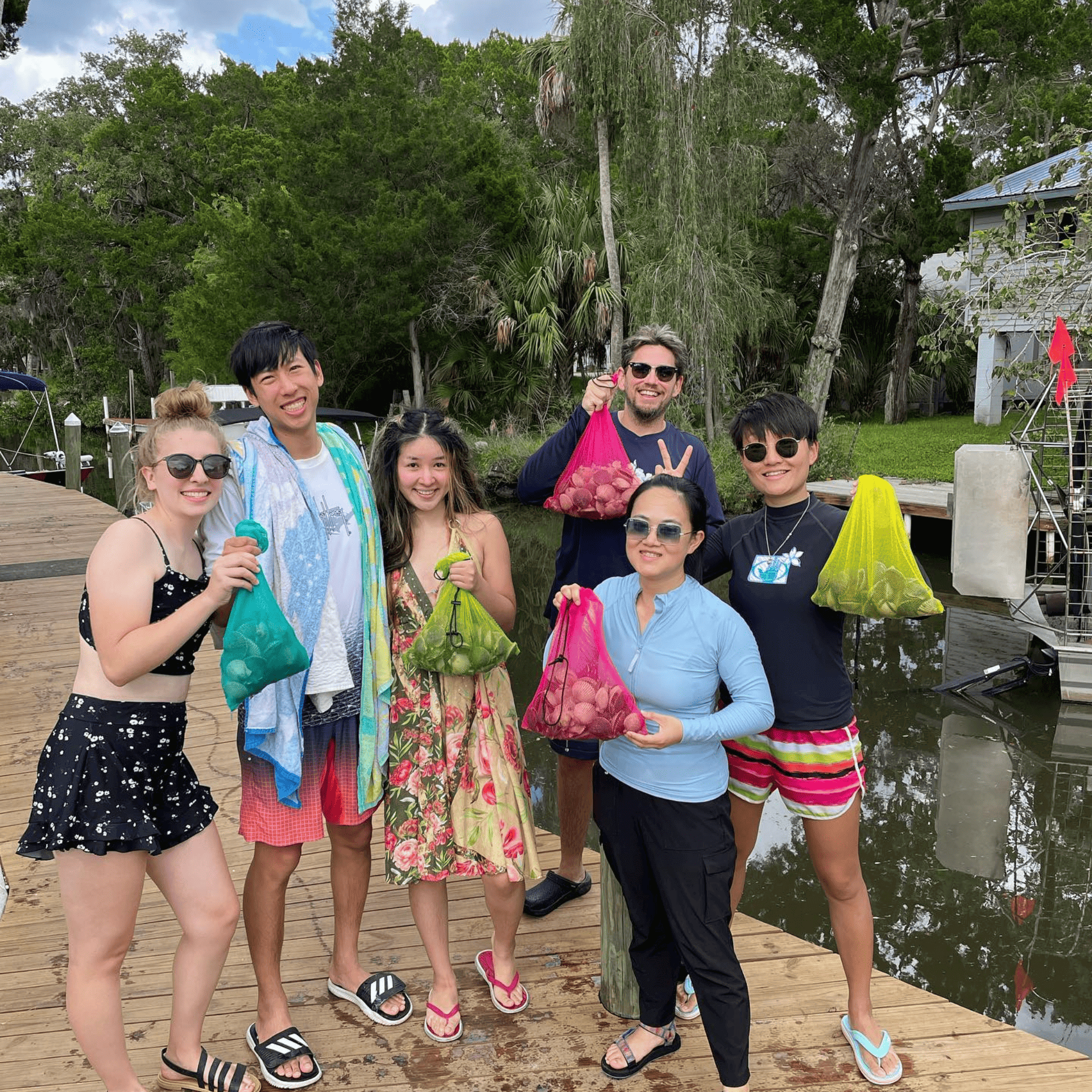 A group of people are posing for a picture on a dock.