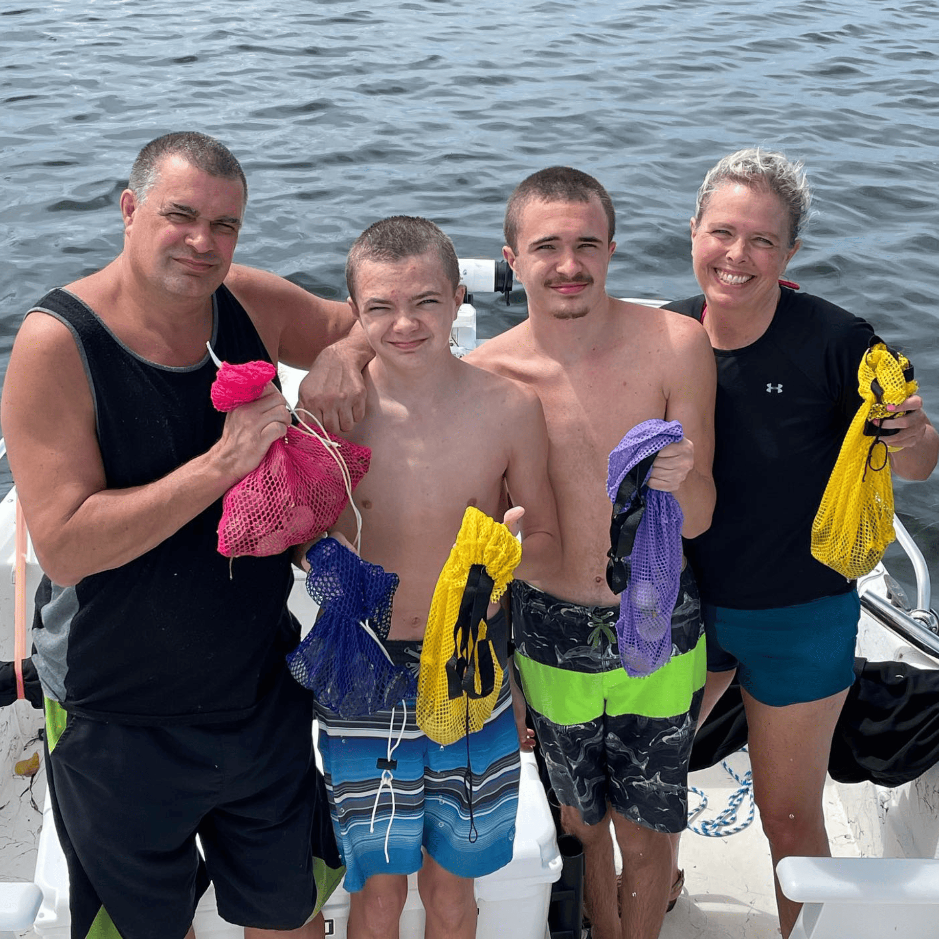 A group of people standing on a boat holding scallops