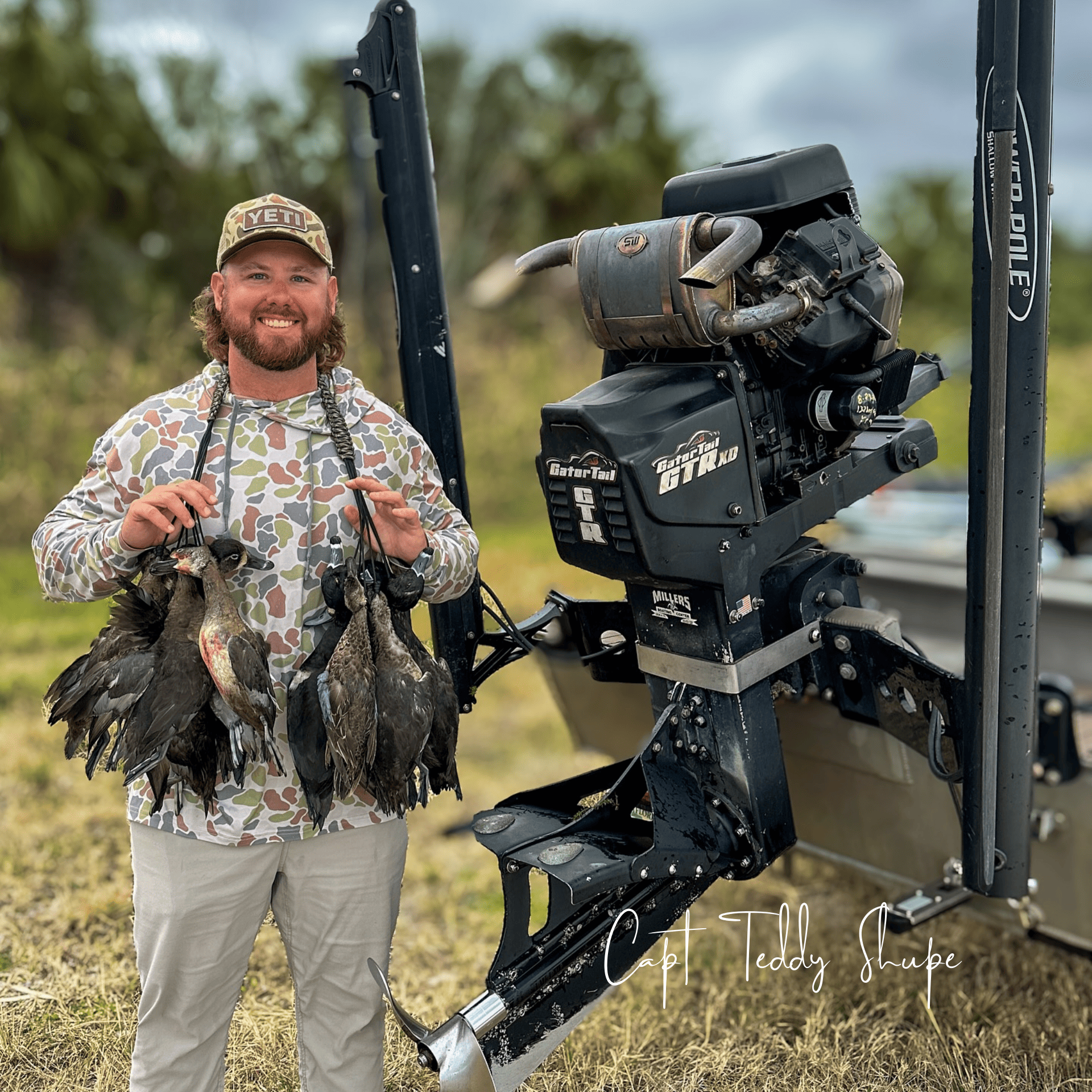 Capt Teddy Shupe holding ducks from a duck hunt