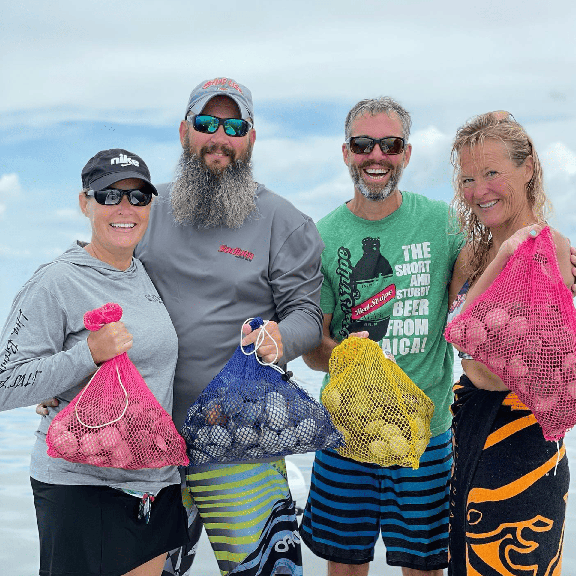 A group of people standing on a boat holding bags of Homosassa scallops.