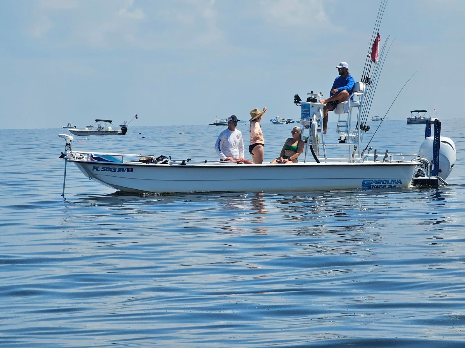 A group of people are sitting on a boat in the ocean.