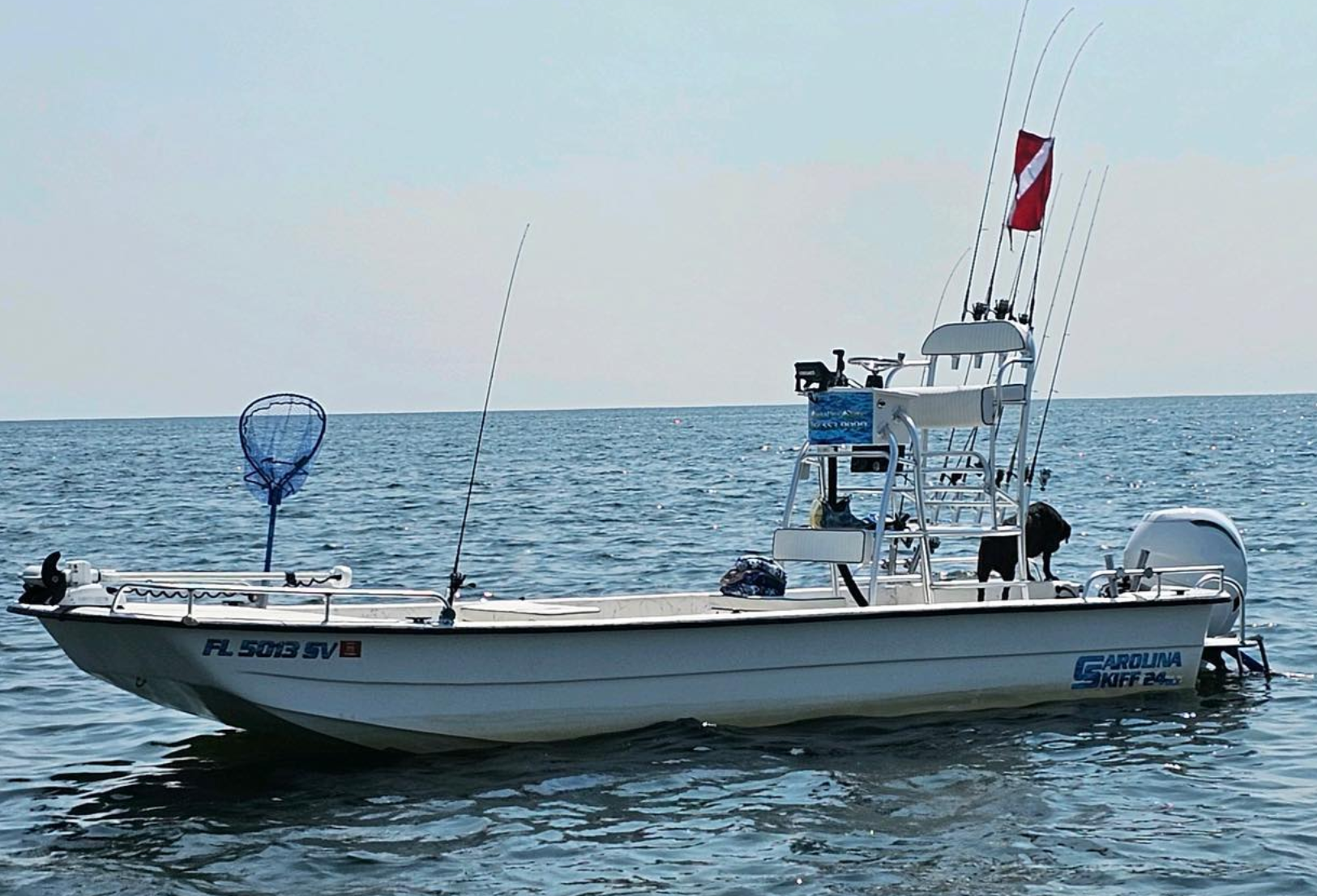 A boat with a fishing net attached to the side of it