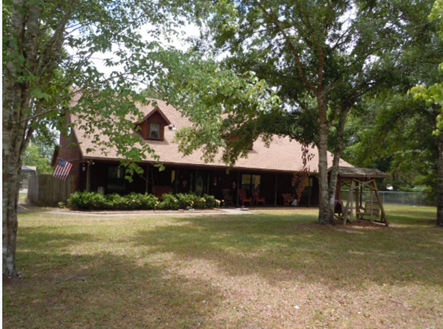 A large house surrounded by trees and a grassy yard, showcasing the work of a residential roofer. A large house surrounded by trees and a grassy yard, showcasing the work of a residential roofer.