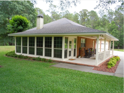 Small brick home with a porch, showcasing a newly remodeled roof done by a residential roofer. Small brick home with a porch, showcasing a newly remodeled roof done by a residential roofer.