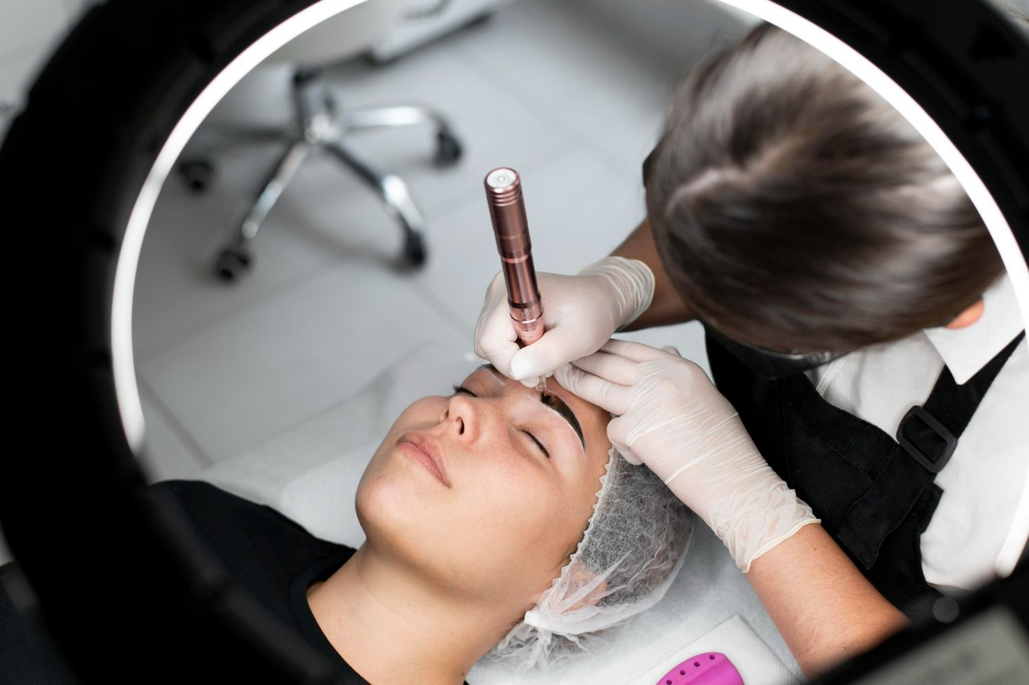 A woman is getting her eyebrows done in a beauty salon.