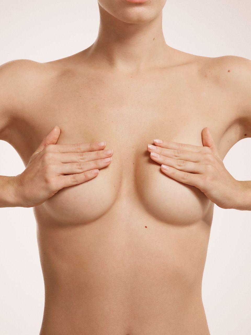 a woman with hands on her breasts