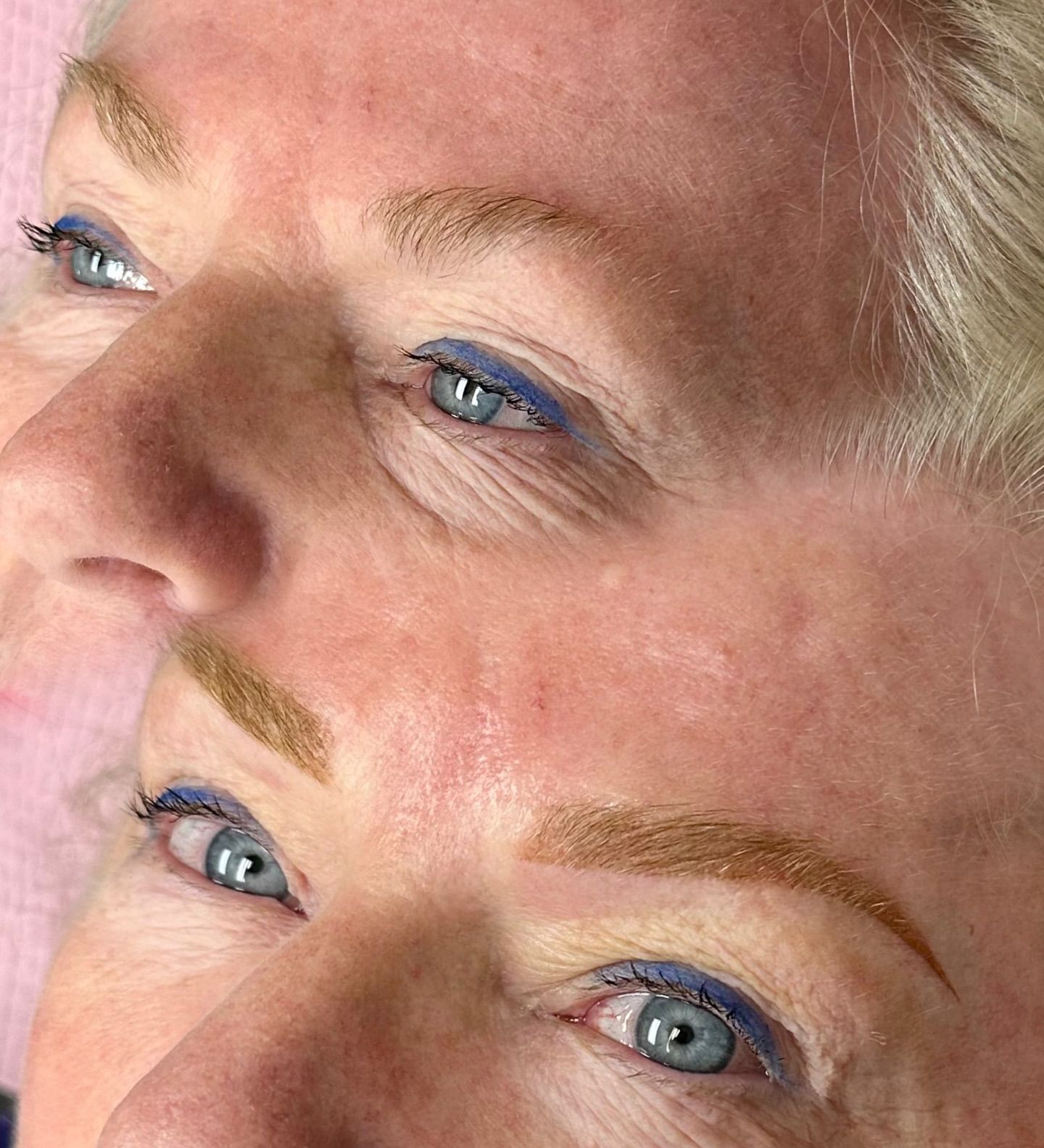 A woman is touching her face with her hand and looking at the camera.