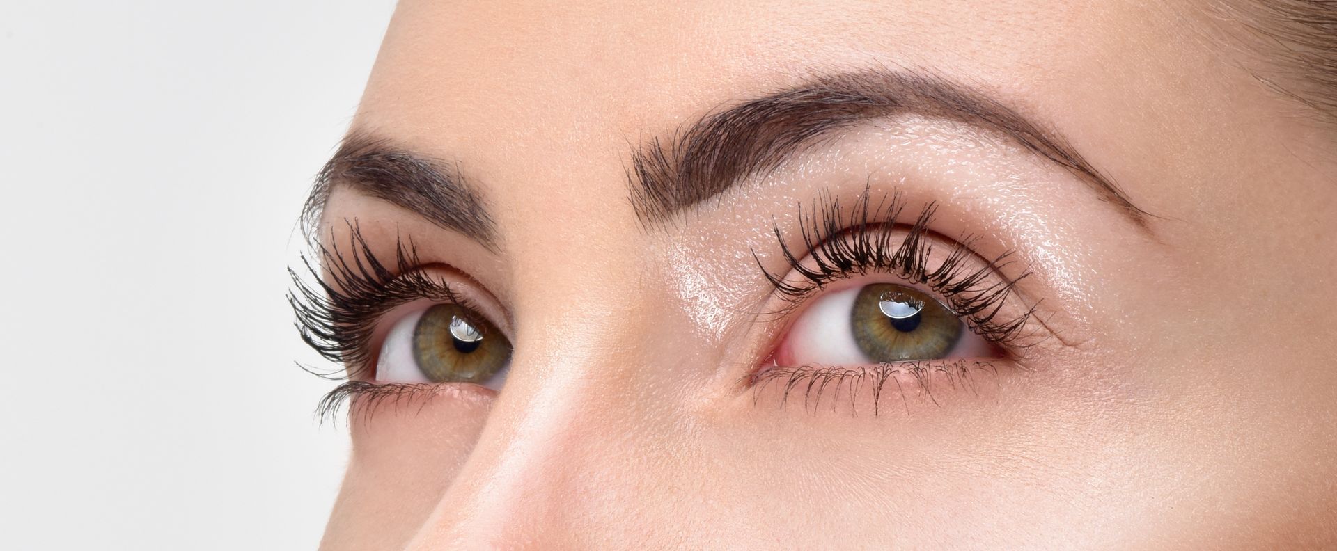 A close up of a woman 's eyes with long eyelashes.